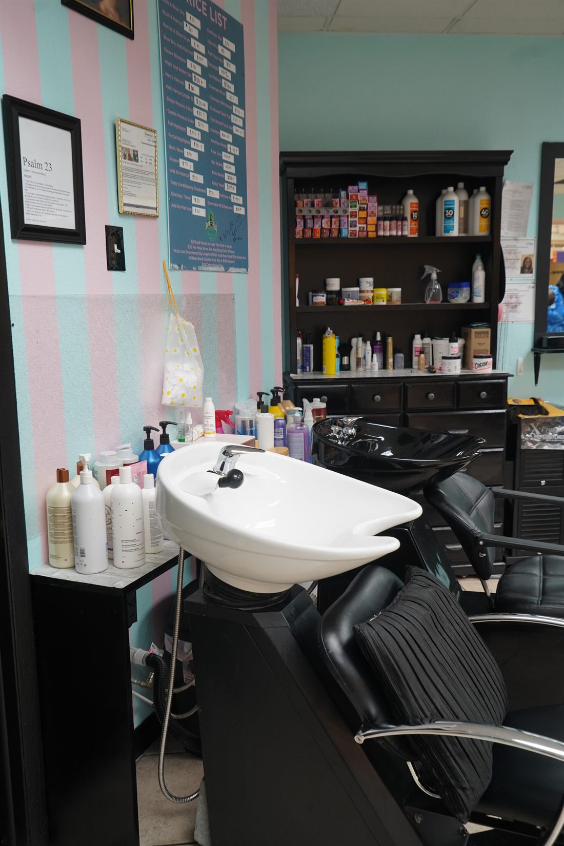 Wash stations against the salon's pink and white striped wall