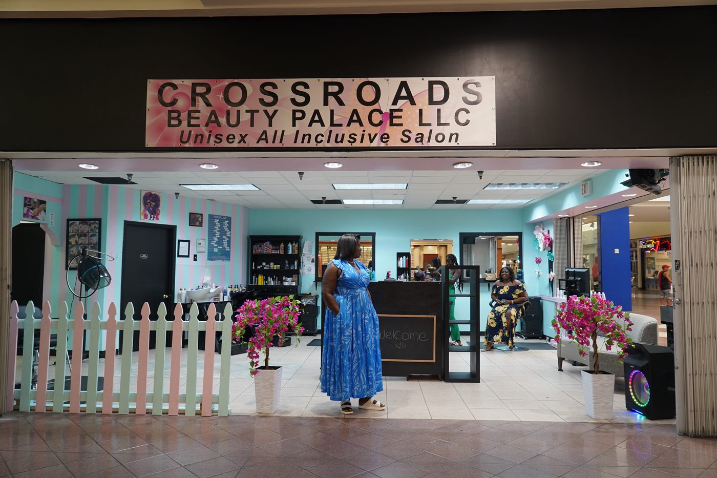 The Crossroads Beauty Palace storefront with its white picket fence