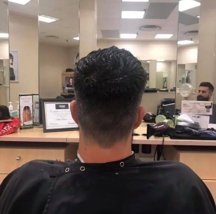 Men's haircut with longer textured top and tapered sides